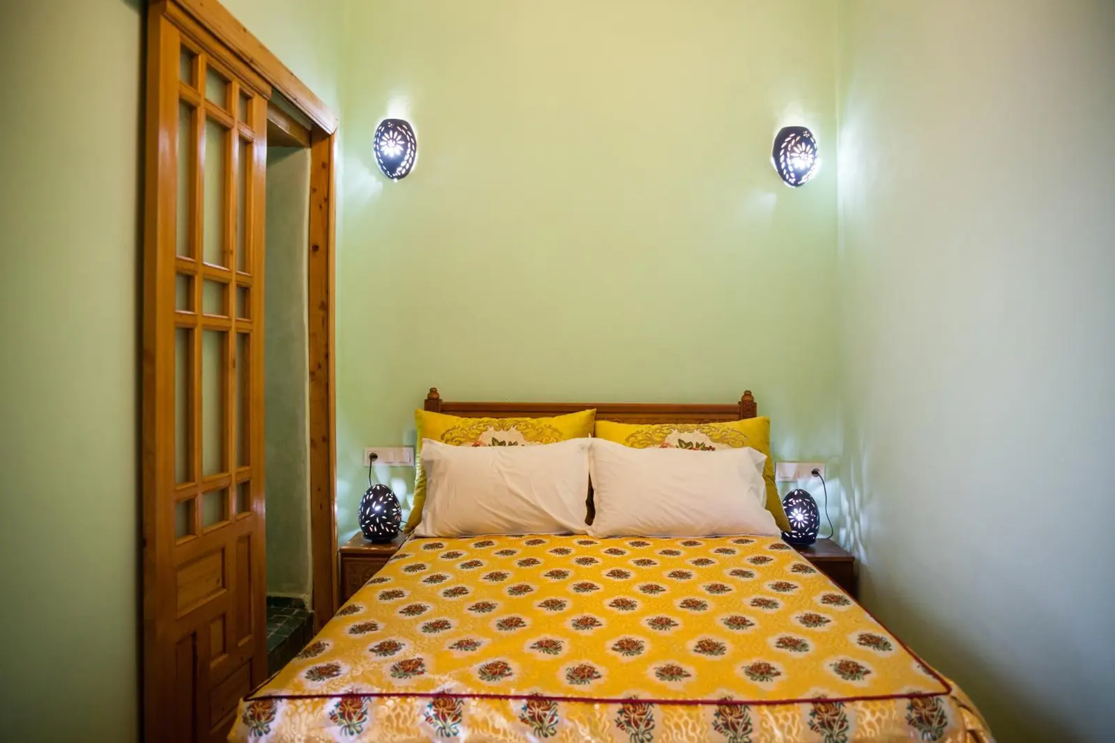 Une chambre familiale Standard, plafond en bois et couvre-lit jaune
